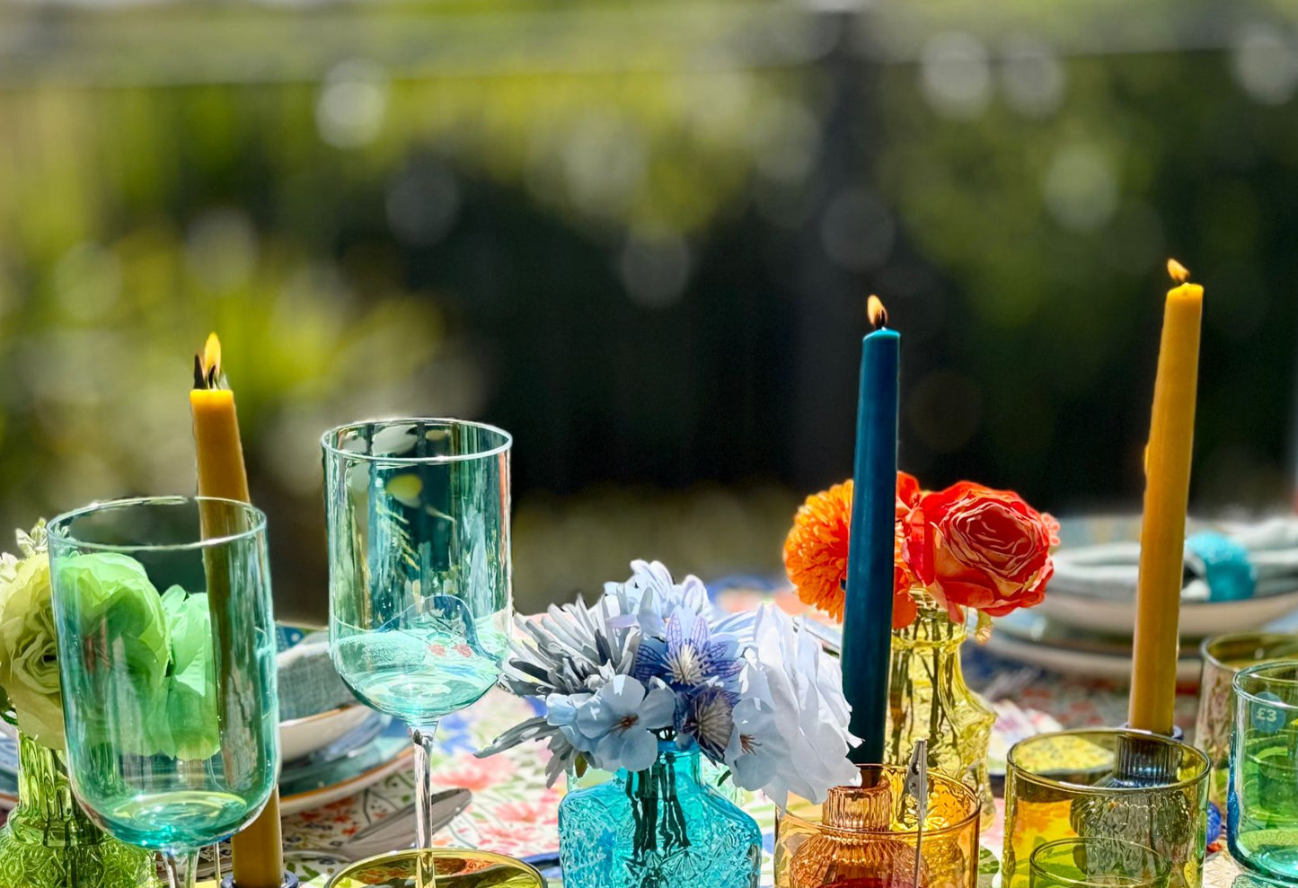 Richly styled dinner table with taper candles and colourful linens, perfect for hosting with a hired tablescape