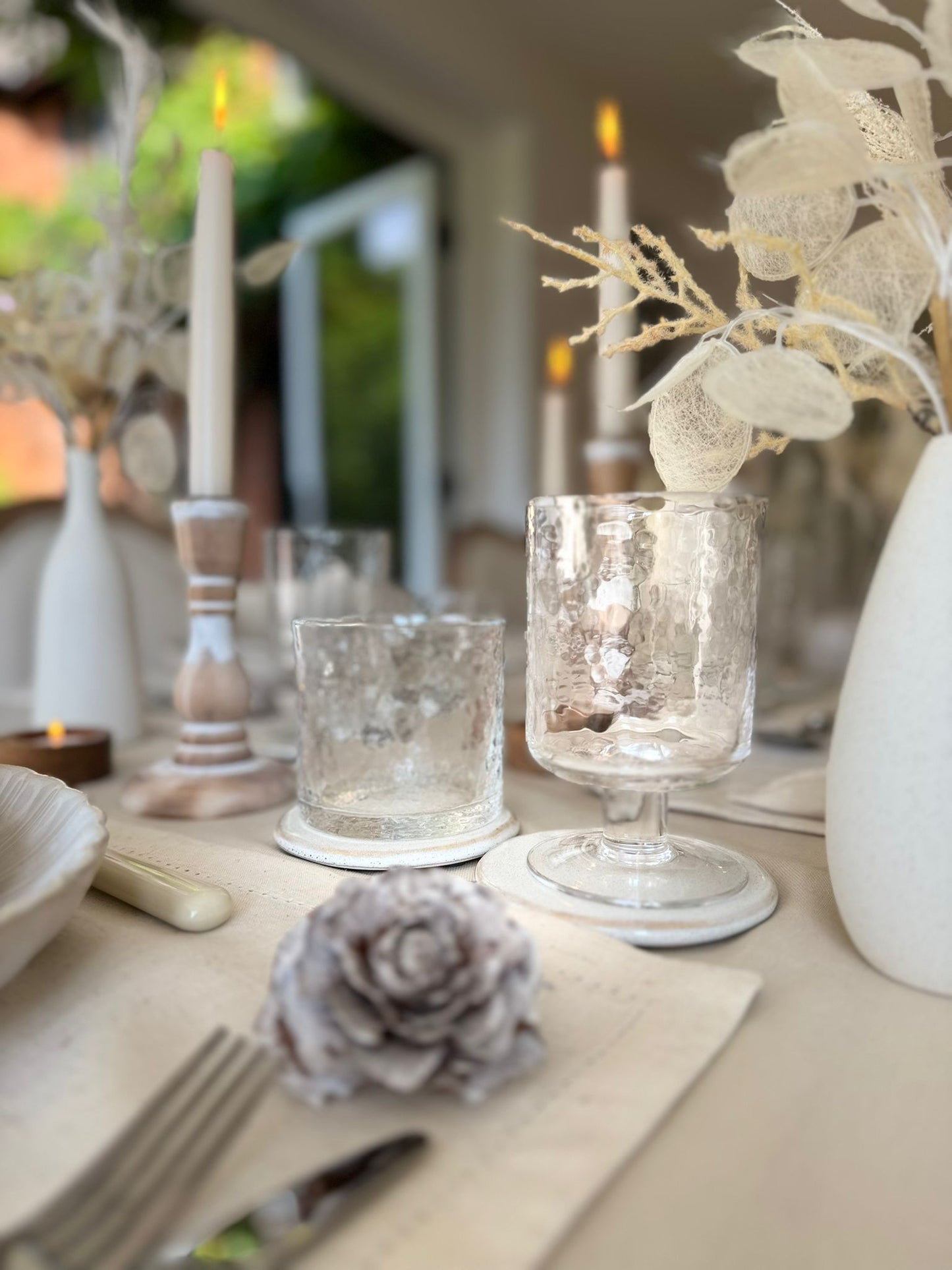 Minimalist tablescape with white crockery, soft beige table linens, and clear glassware from the Simplicity Collection