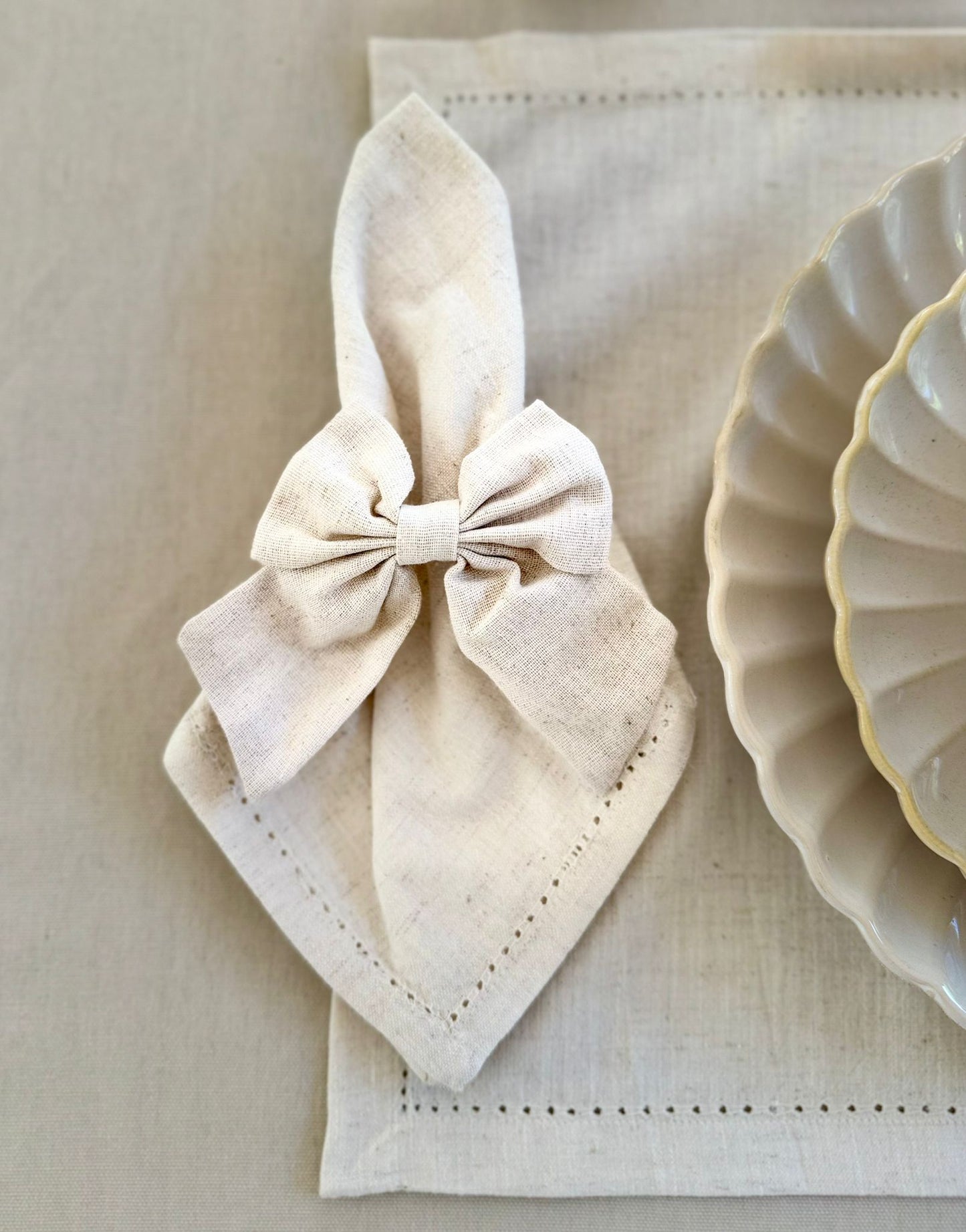 Elegant beige table linens and napkins on a simple, modern tablescape. For hire/rent