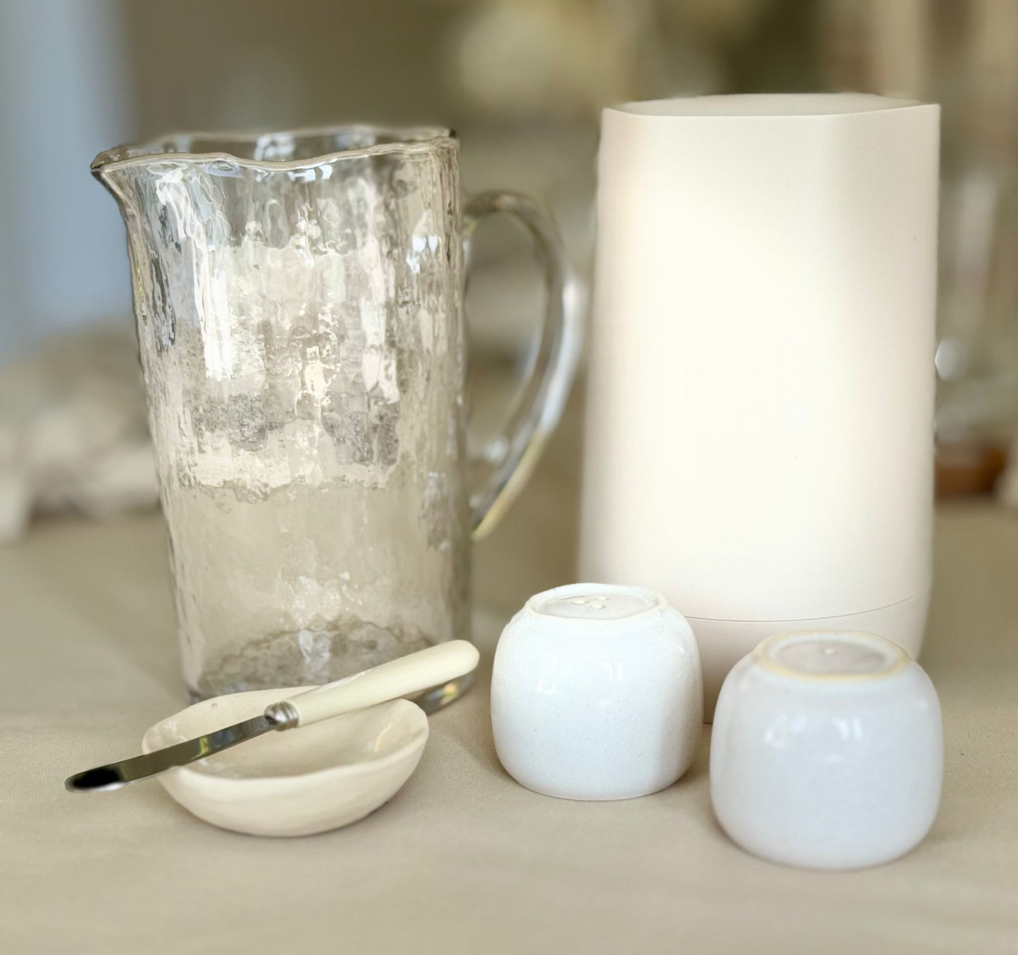 Neutral toned, water jug, salt and pepper, butter dish and wine cooler included in simplicity rental collection