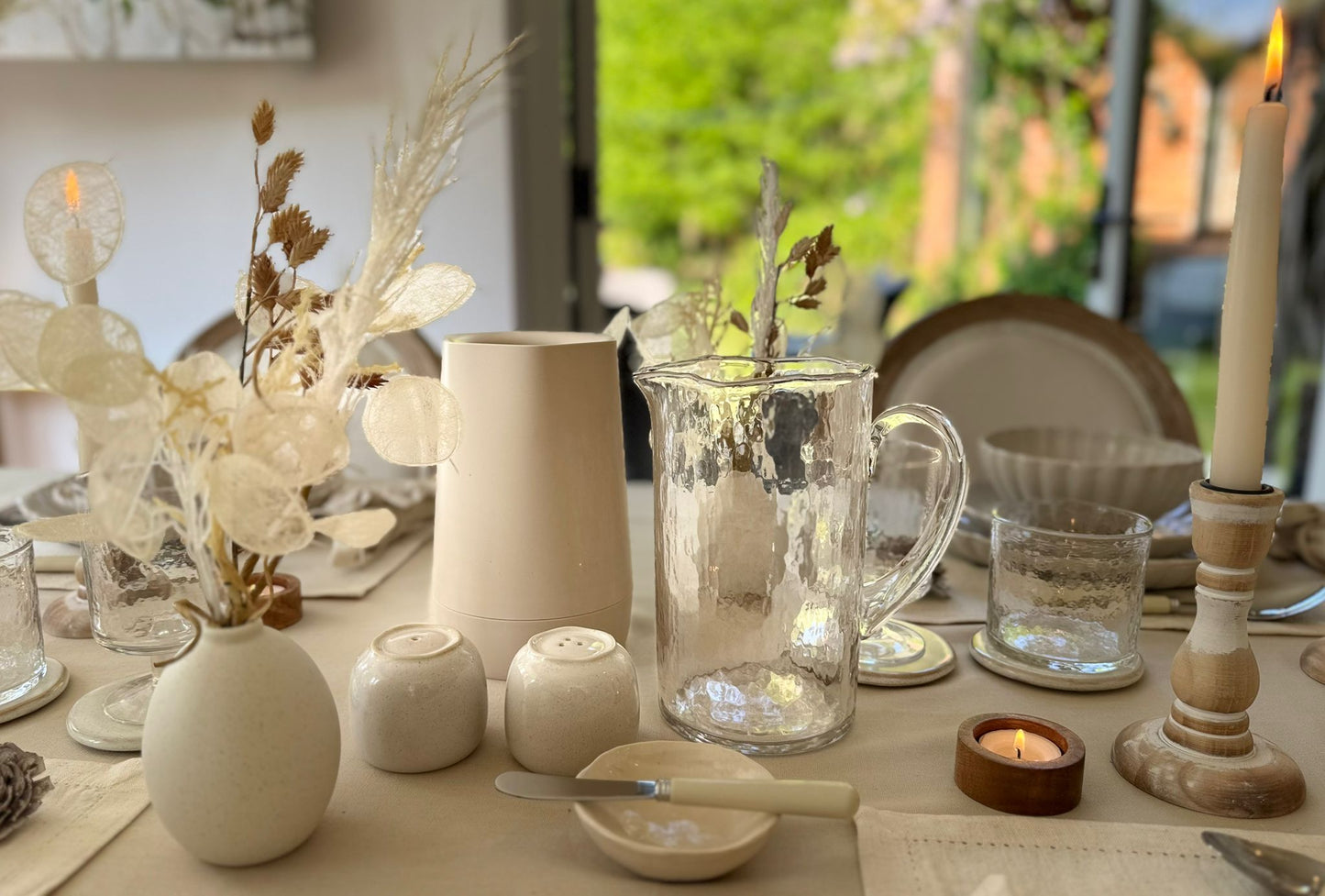 Neutral toned, water jug, salt and pepper, butter dish and wine cooler included in simplicity rental collection