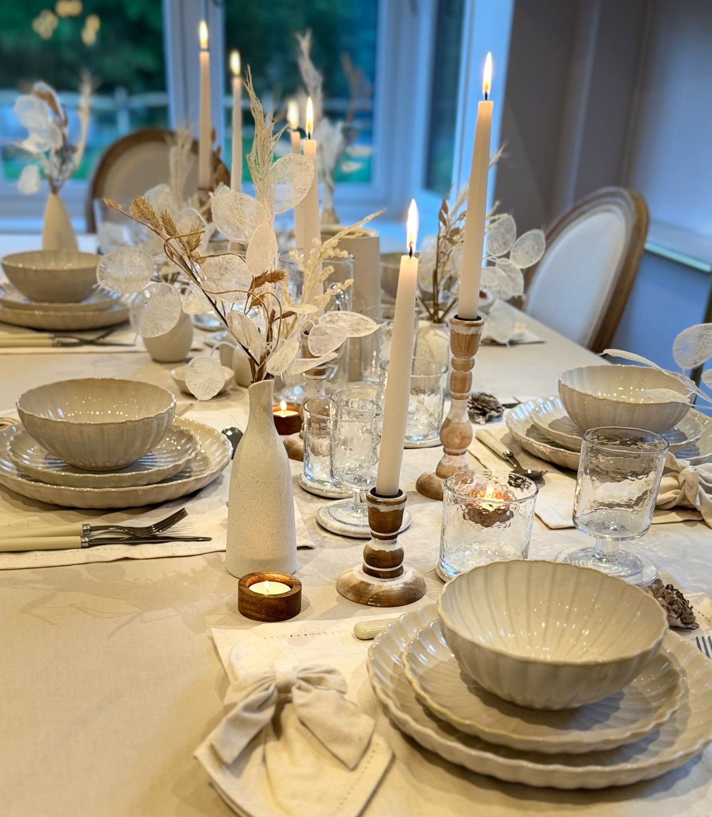 Minimalist tablescape with white crockery, soft beige linens, and clear glassware from the Simplicity Collection