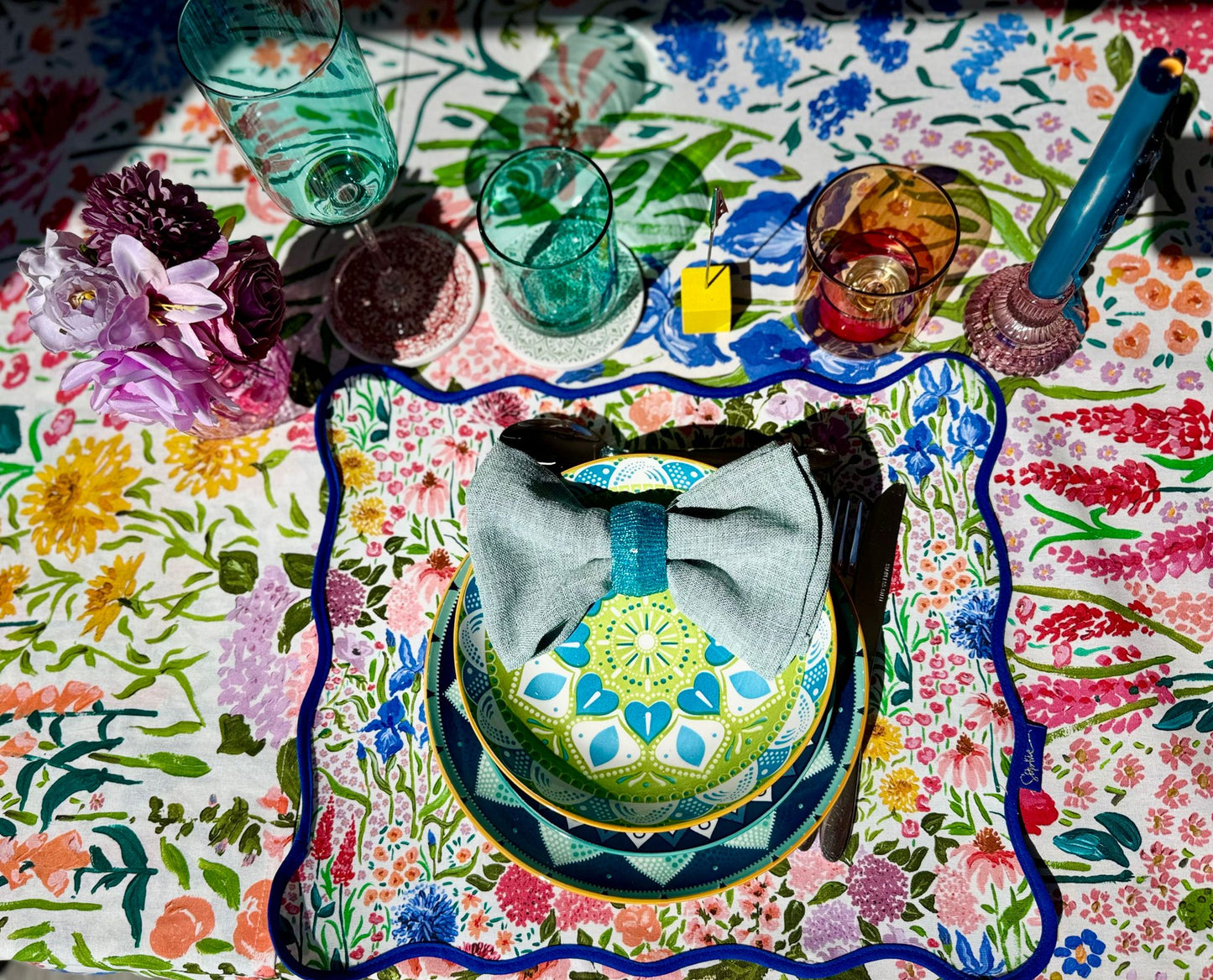 Top-down view of a single place setting from the Vibrant tablescape rental collection including accesories