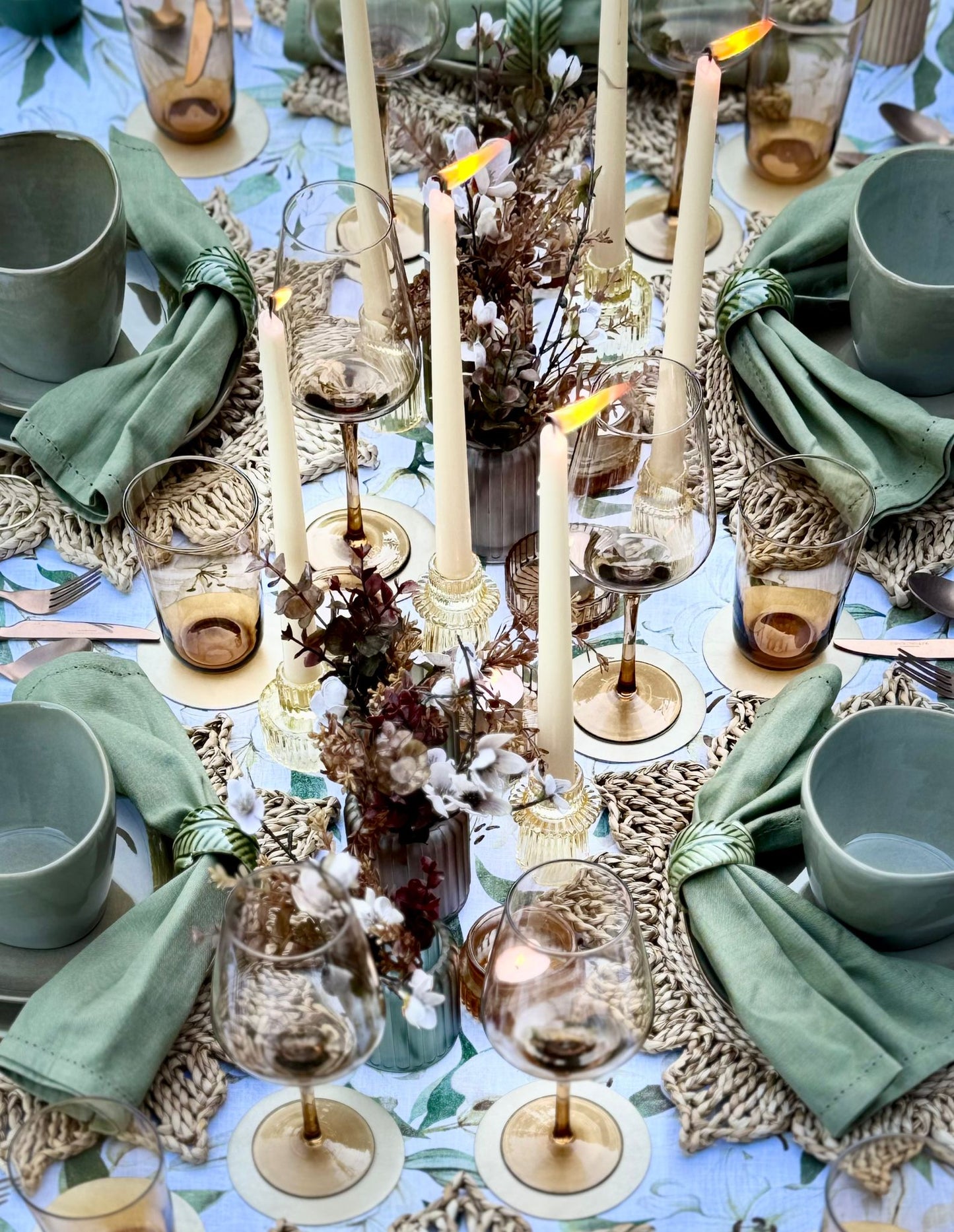 op-down view of an earthy toned, natural tablescape styled with coordinated rental tableware