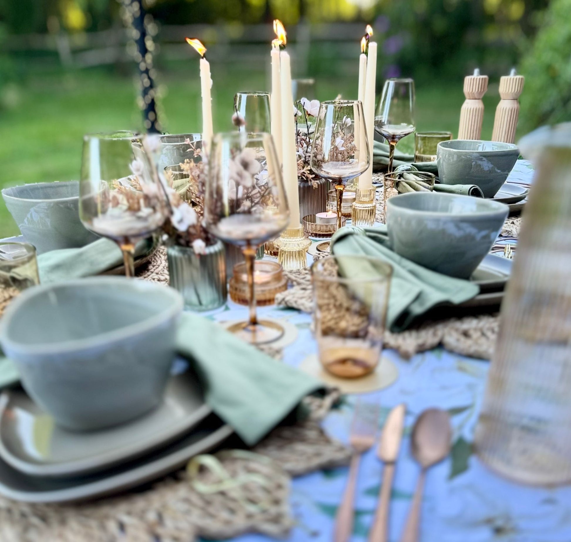 Neutral-toned tablescape featuring stoneware plates, linen napkins, and elegant glassware from the Natural Collection