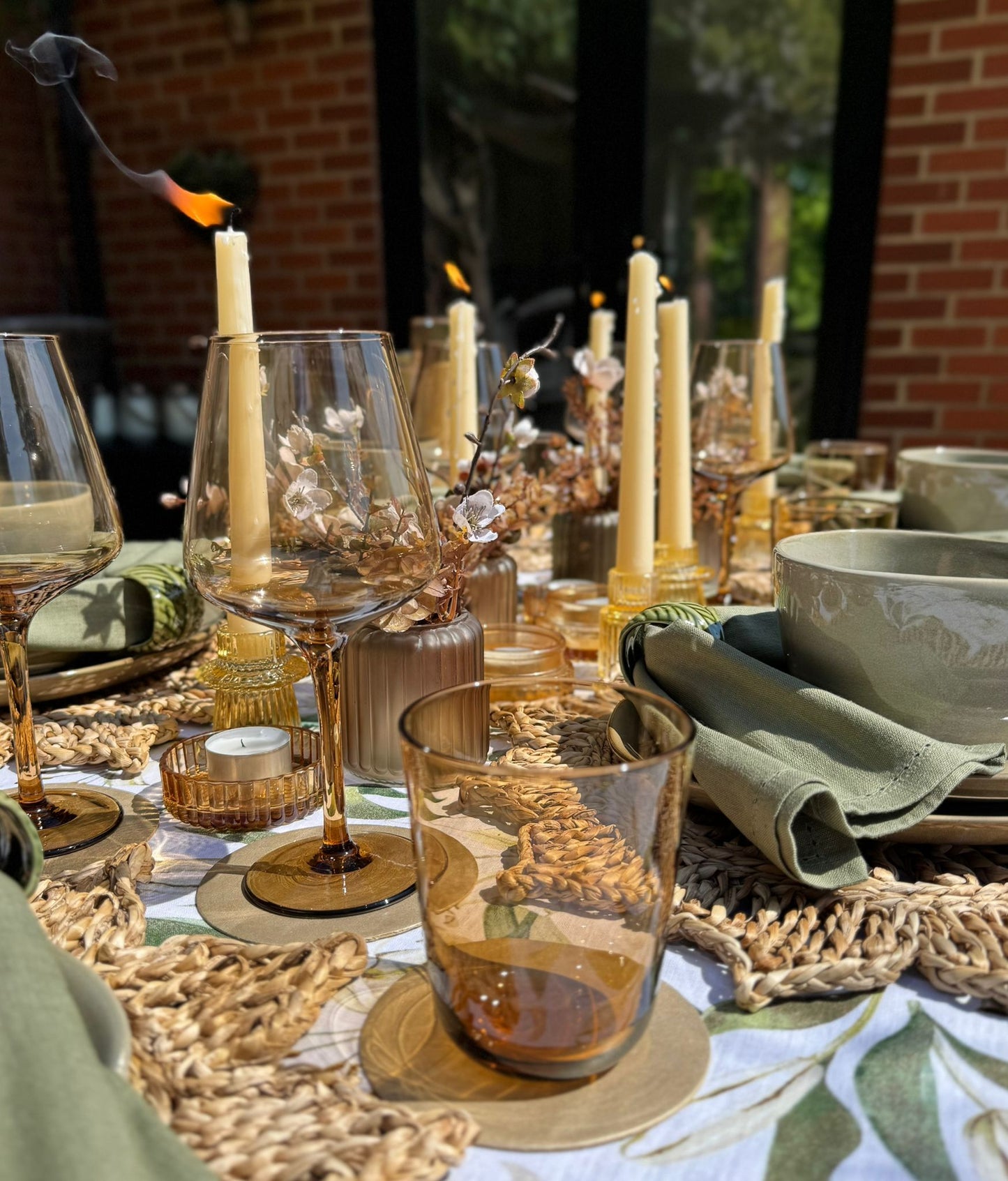Amber glassware and soft linen napkins on a curated table setting for intimate hosting